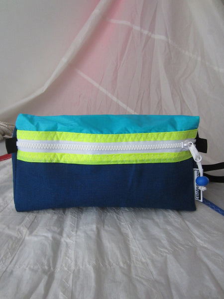 Trianglar shaped storage case for toiletries, and essentials for travel. Sits solidly on surface. Wrist strap made of webbing and heavy duty zip. Lined.