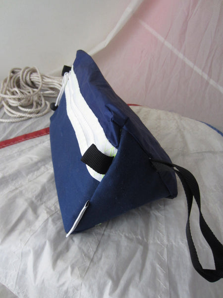 Trianglar shaped storage case for toiletries, and essentials for travel. Sits solidly on surface. Wrist strap made of webbing and heavy duty zip. Lined.